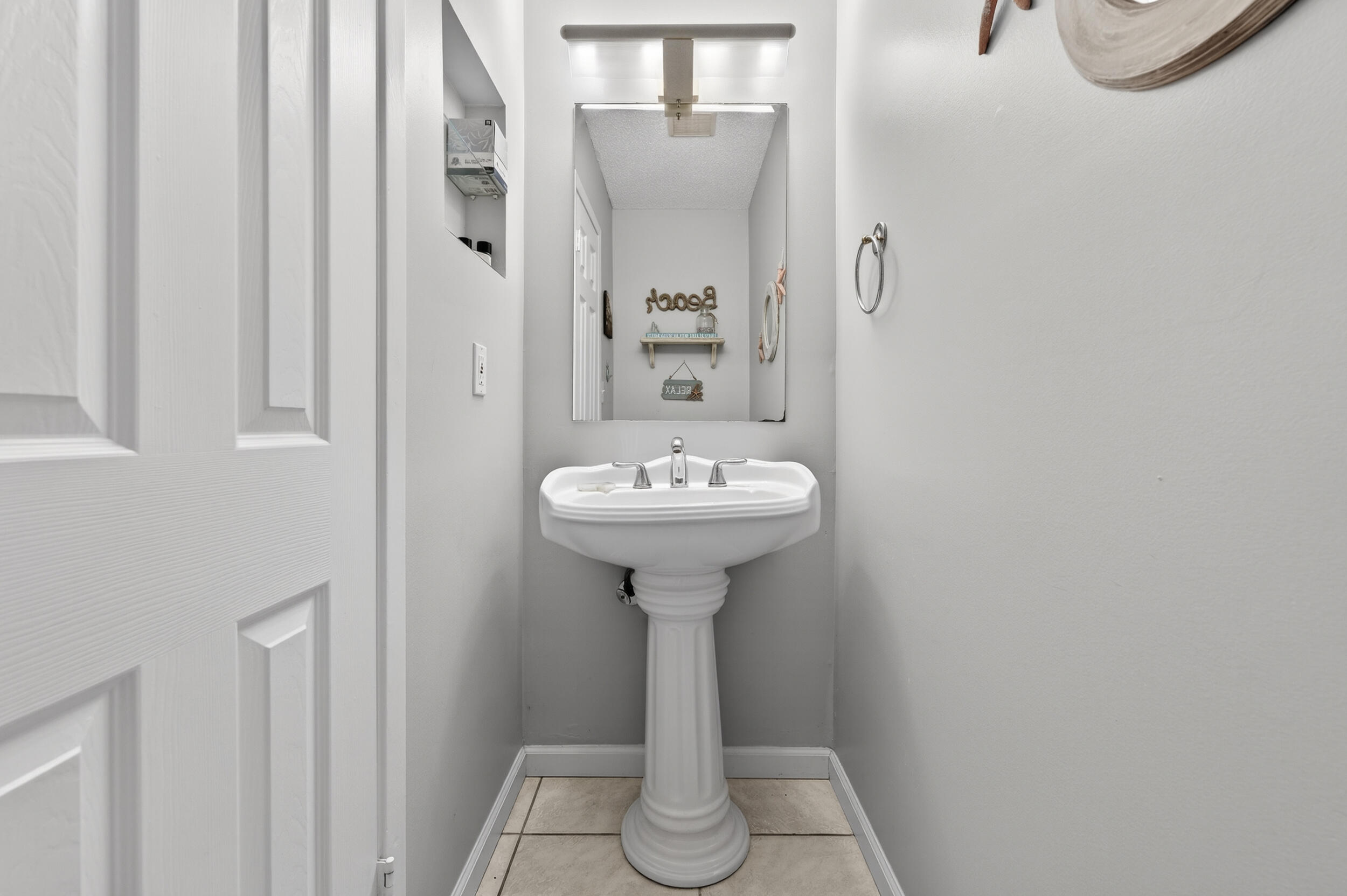 17620 Front Beach Road, Unit BB6 Panama City Beach, FL 32413 - Photo 18 of 47 a bathroom with a sink toilet and a mirror