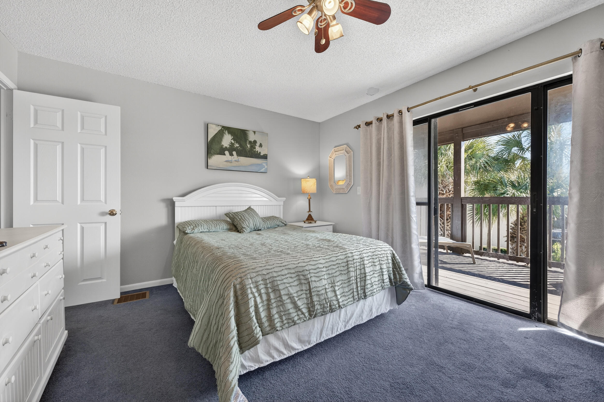 17620 Front Beach Road, Unit BB6 Panama City Beach, FL 32413 - Photo 22 of 47 a bedroom with a bed and a chandelier