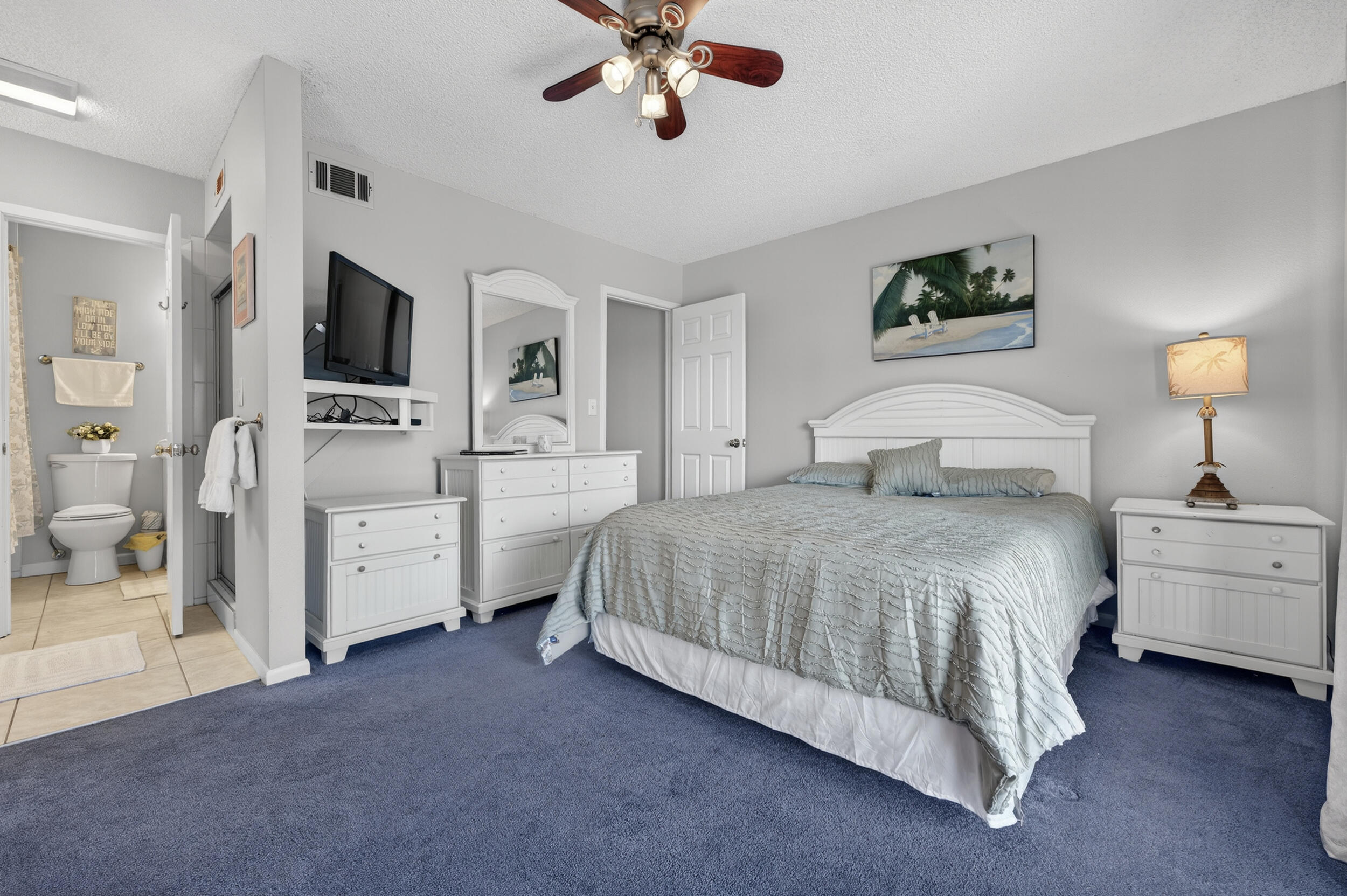 17620 Front Beach Road, Unit BB6 Panama City Beach, FL 32413 - Photo 23 of 47 a bedroom with a large bed a flat tv screen and chandelier