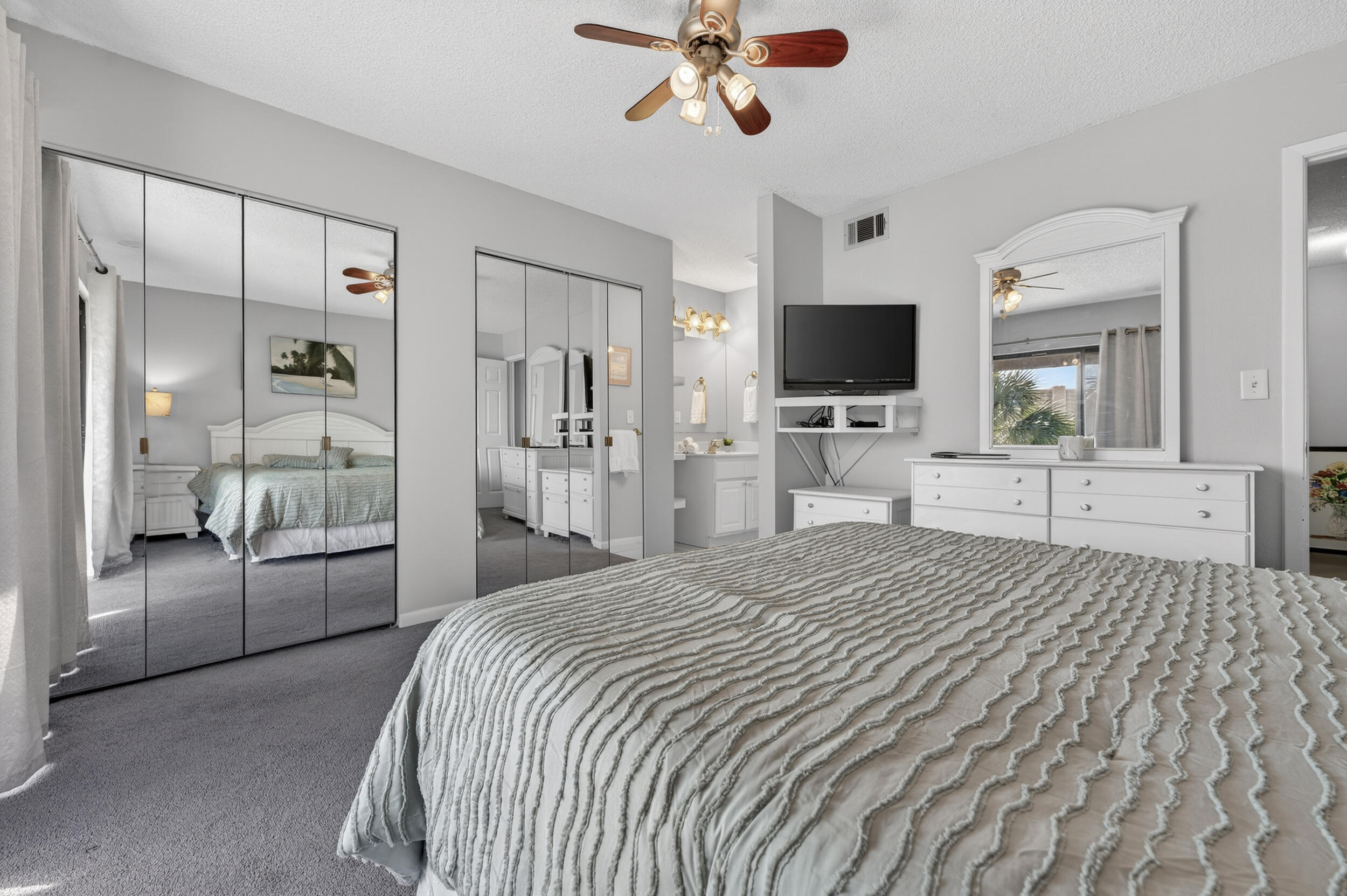 17620 Front Beach Road, Unit BB6 Panama City Beach, FL 32413 - Photo 24 of 47 a large bedroom with a bed and a flat screen tv