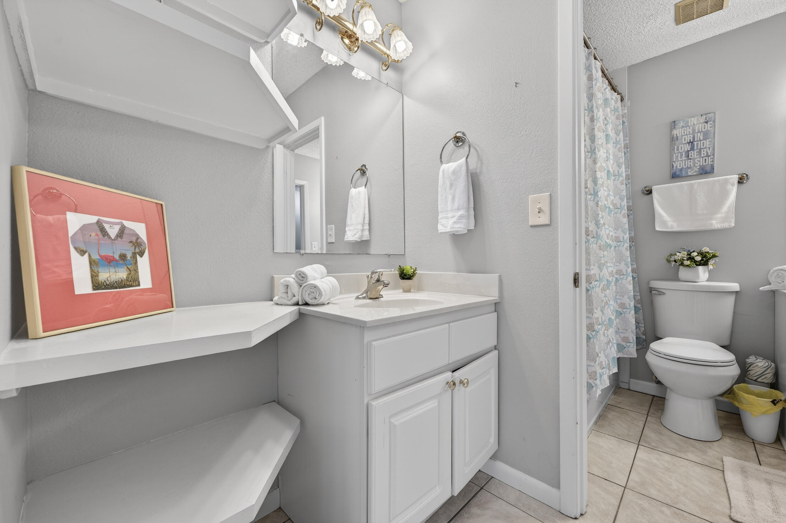 17620 Front Beach Road, Unit BB6 Panama City Beach, FL 32413 - Photo 28 of 47 a bathroom with a sink a toilet and a mirror