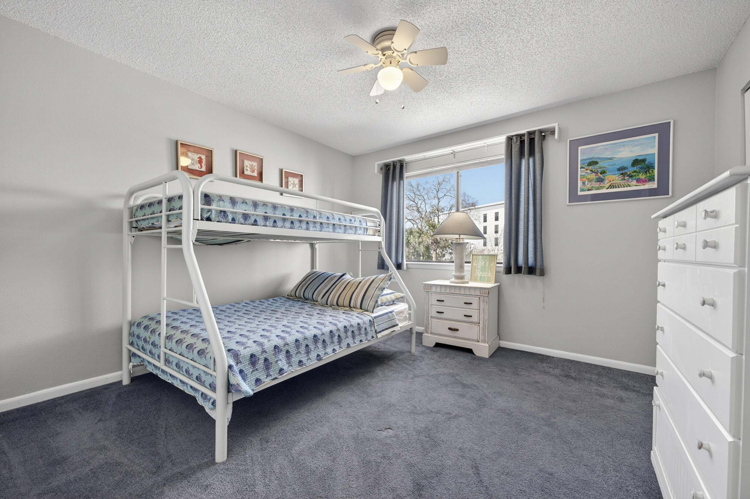 17620 Front Beach Road, Unit BB6 Panama City Beach, FL 32413 - Photo 32 of 47 a bedroom with a bed and a chandelier