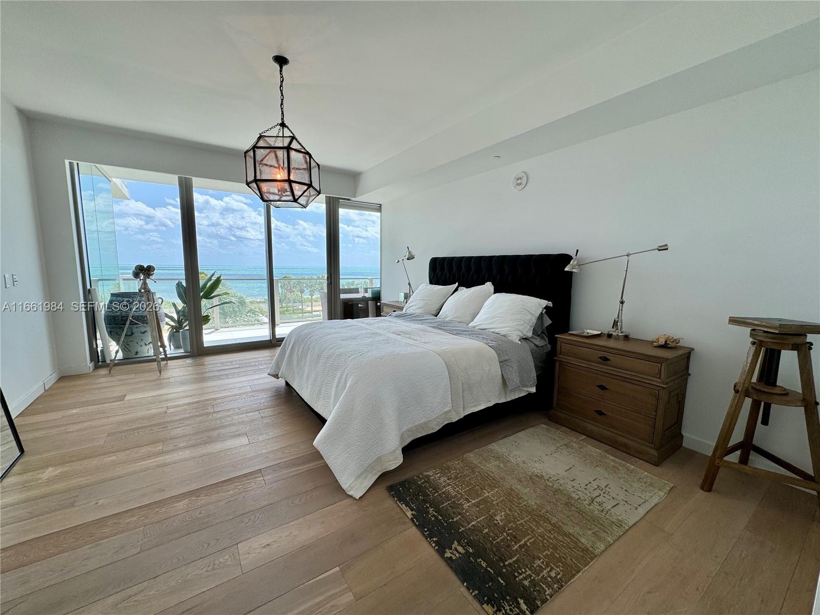 350 Ocean Drive, Unit 406N Key Biscayne, FL 33149 - Photo 22 of 38 a spacious bedroom with a bed and a table