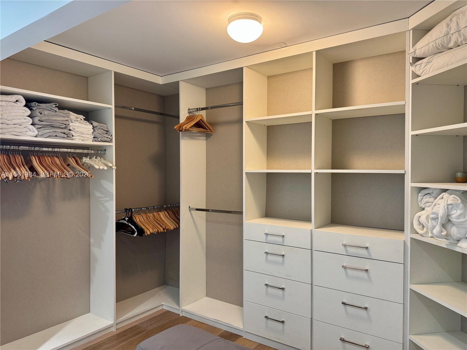 350 Ocean Drive, Unit 406N Key Biscayne, FL 33149 - Photo 24 of 38 a view of walk in closet with clothes and shoes