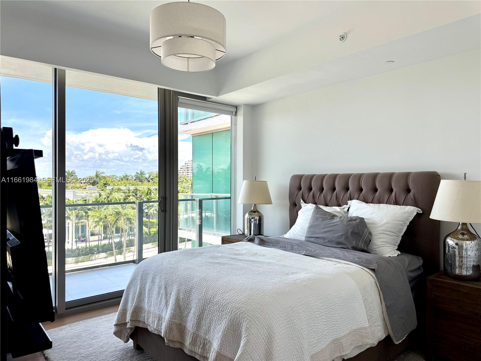 350 Ocean Drive, Unit 406N Key Biscayne, FL 33149 - Photo 27 of 38 a bedroom with a large bed and a window