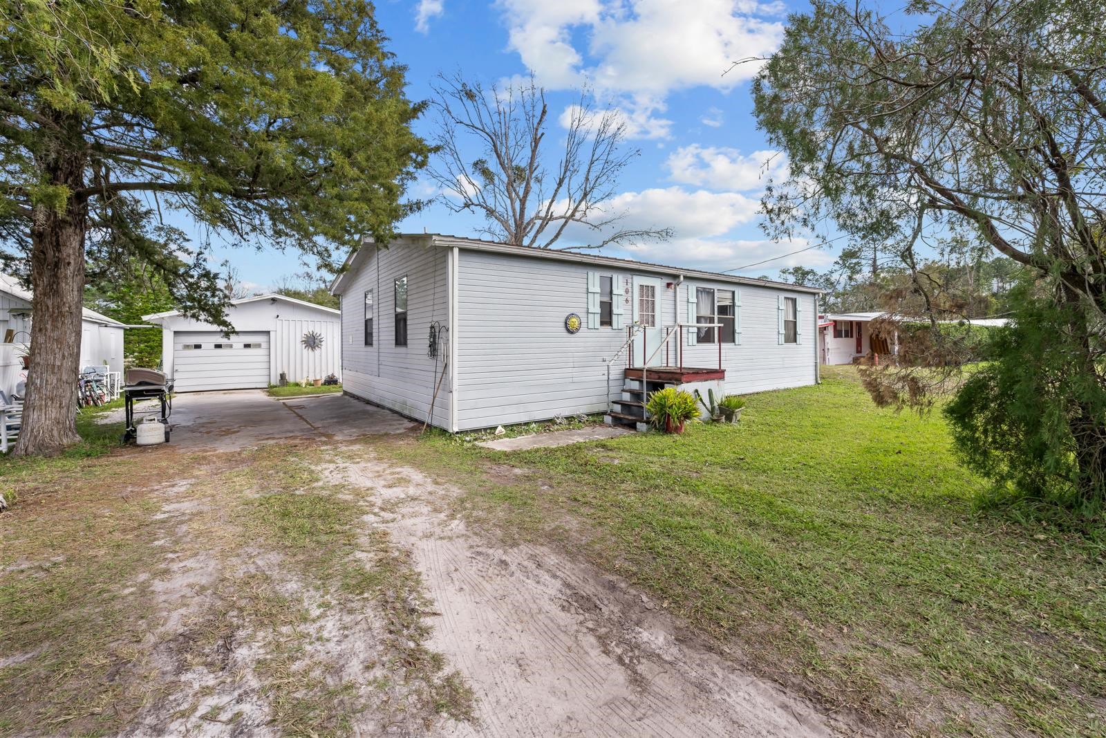 106 Lake Lane Crescent City, FL 32112 - Photo 2 of 25 a view of a house with a yard and tree