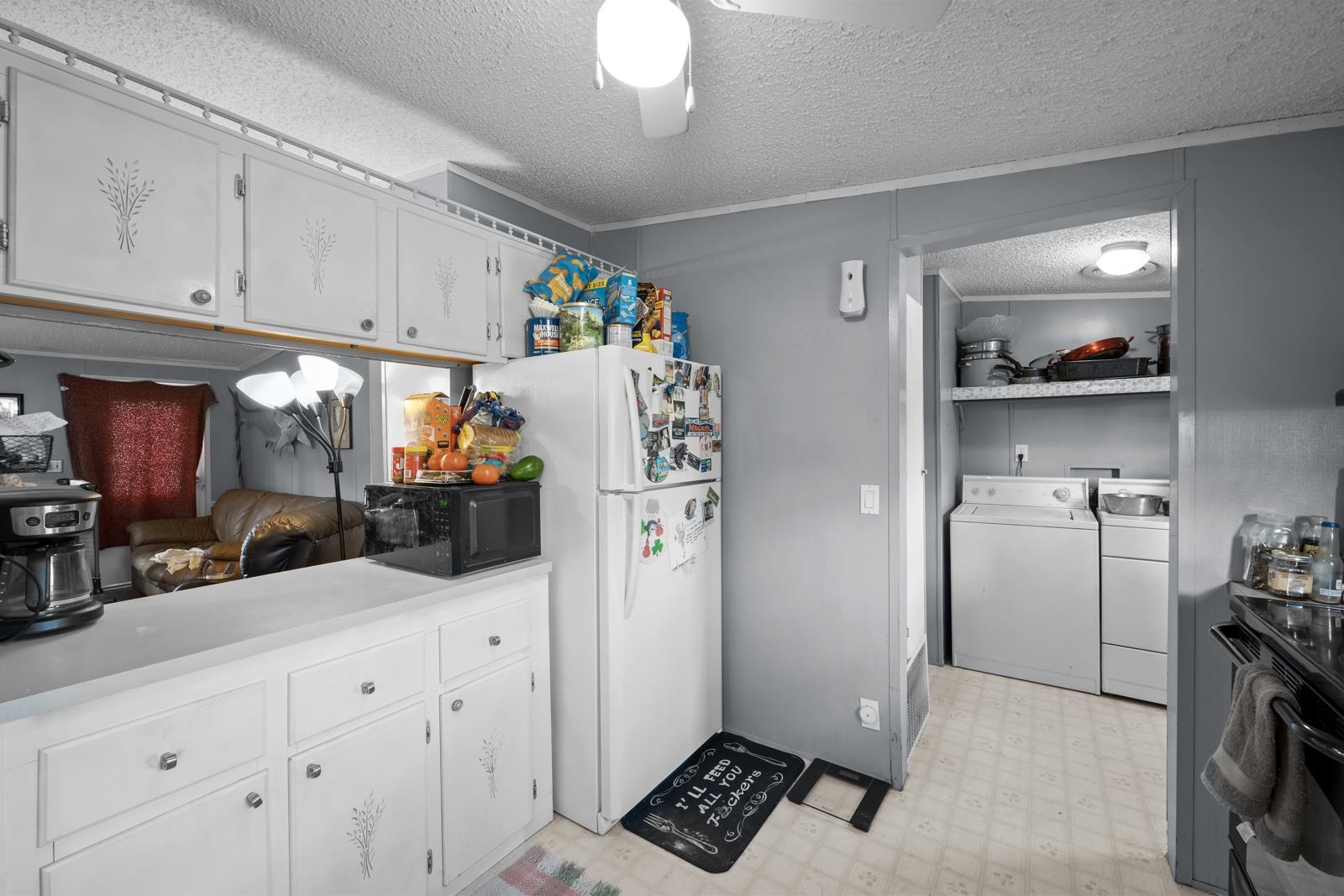 106 Lake Lane Crescent City, FL 32112 - Photo 9 of 25 a kitchen with stainless steel appliances a refrigerator a sink and cabinets