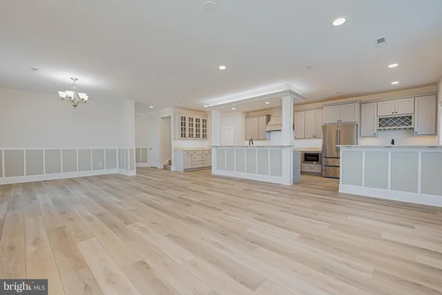 a view of a kitchen with a sink and wooden floor