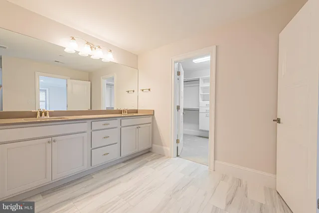 a white toilet sitting next to a bathroom sink