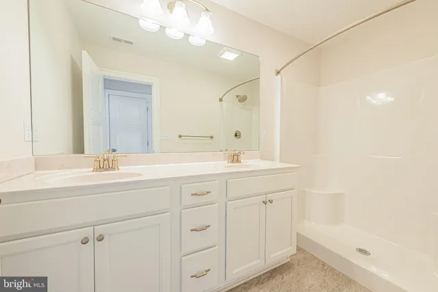 a kitchen with granite countertop cabinets stainless steel appliances and wooden floor