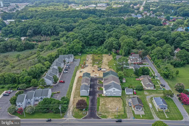 a view of a kitchen with wooden floor and electronic appliances