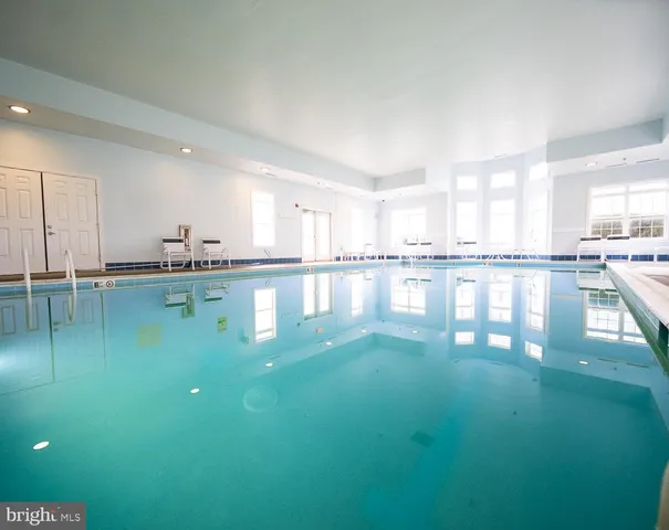 a kitchen with a large window cabinets and swimming pool