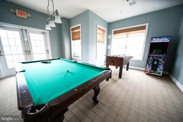 a room with pool table and a window