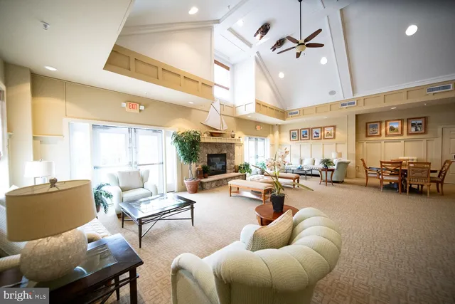a living room with furniture and a dining table