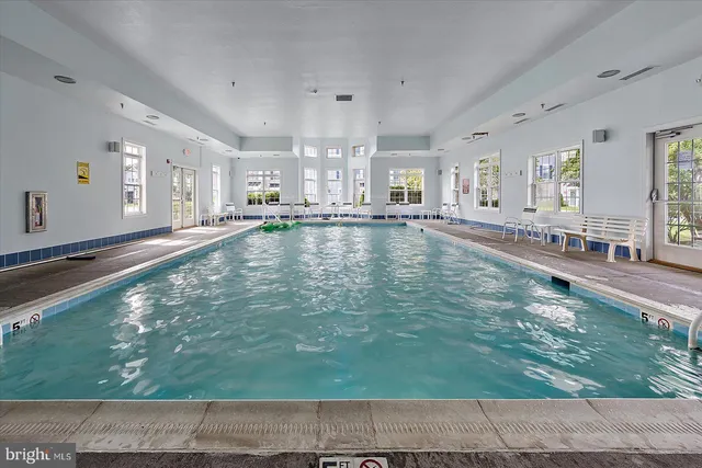 a close view of a stove a sink a refrigerator and cabinets