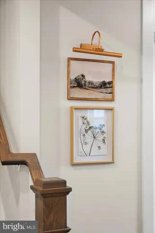 a white toilet sitting next to a small window