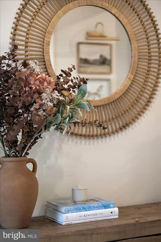 a spacious bedroom with a bed a dresser and a large window