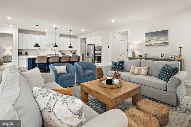 a view of a patio with couches chairs and a yard