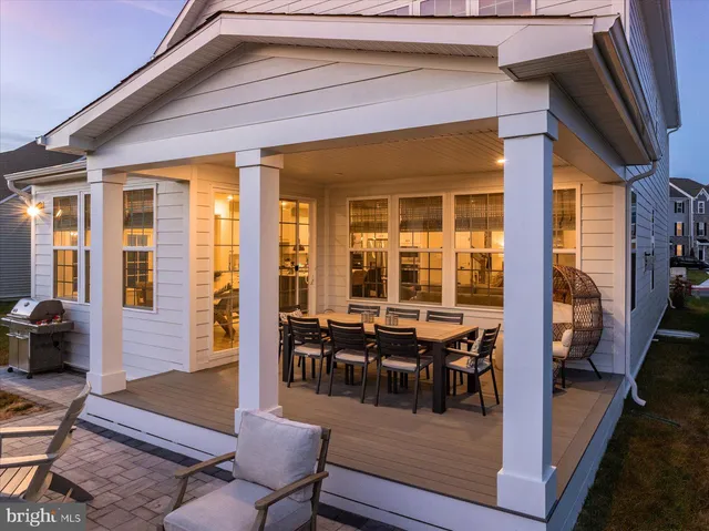 a view of a bedroom with wooden floor and windows
