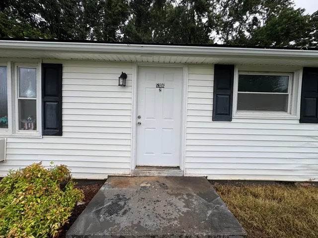 a view of a house with a small yard