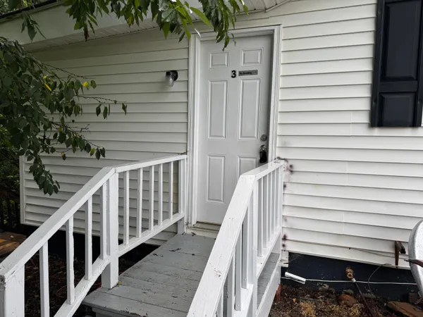 a view of a balcony with wooden stairs