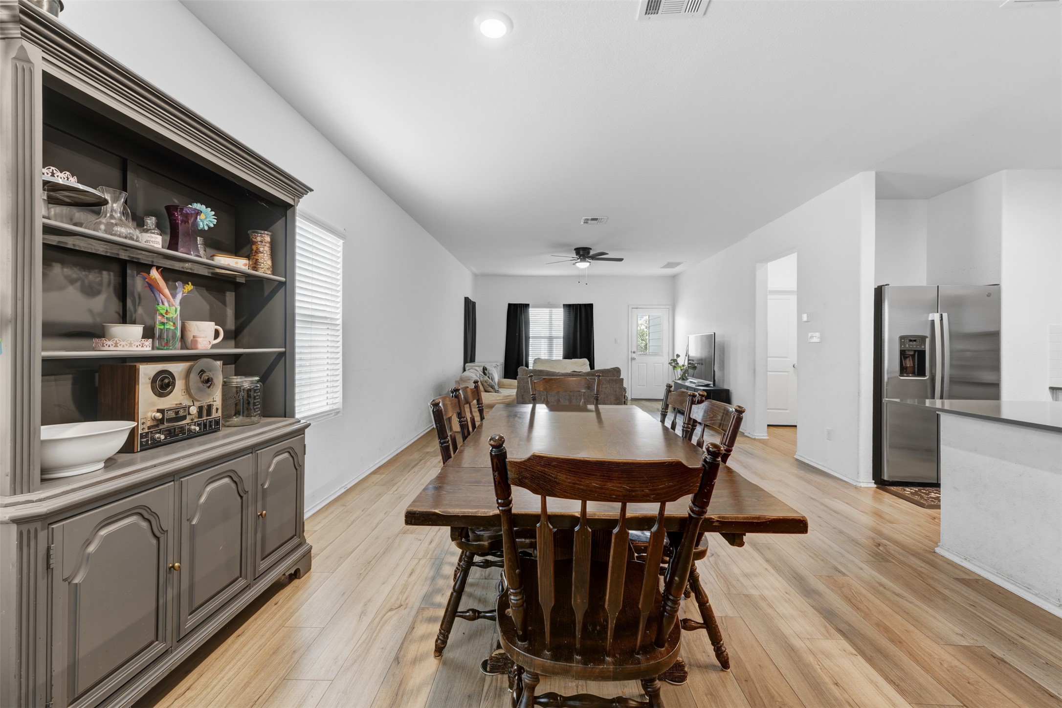 413 Perfect World Loop Jarrell, TX 76537 - Photo 38 of 39 An open floorplan seamlessly connects the dining area, living space, and a well-appointed kitchen.