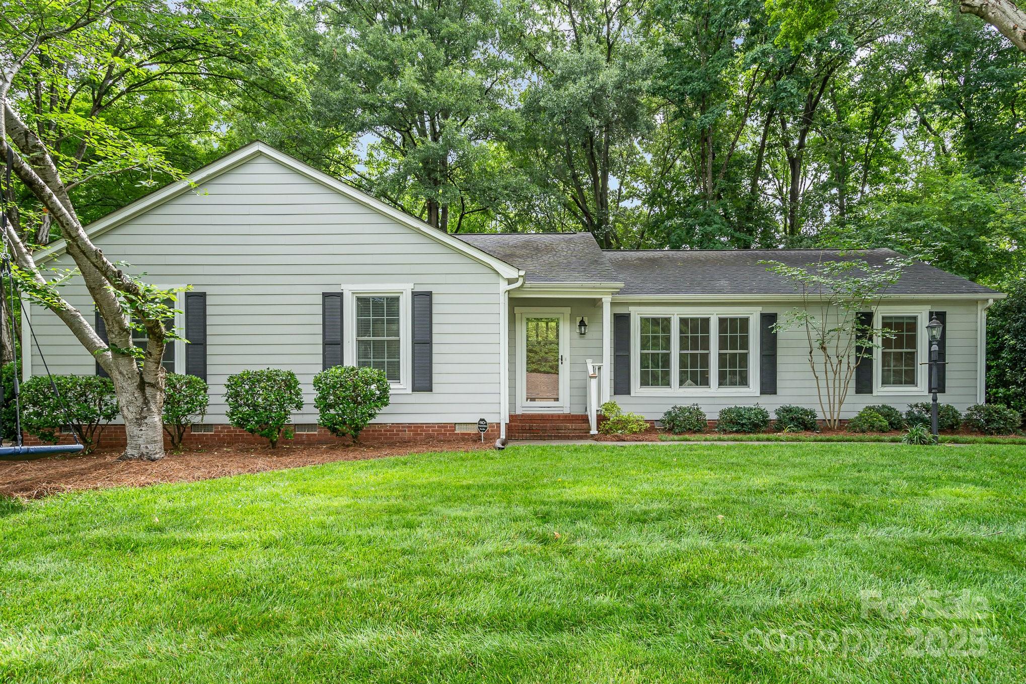 6749 Windyrush Road Charlotte, NC 28226 - Photo 1 of 30 front view of a house that has a yard