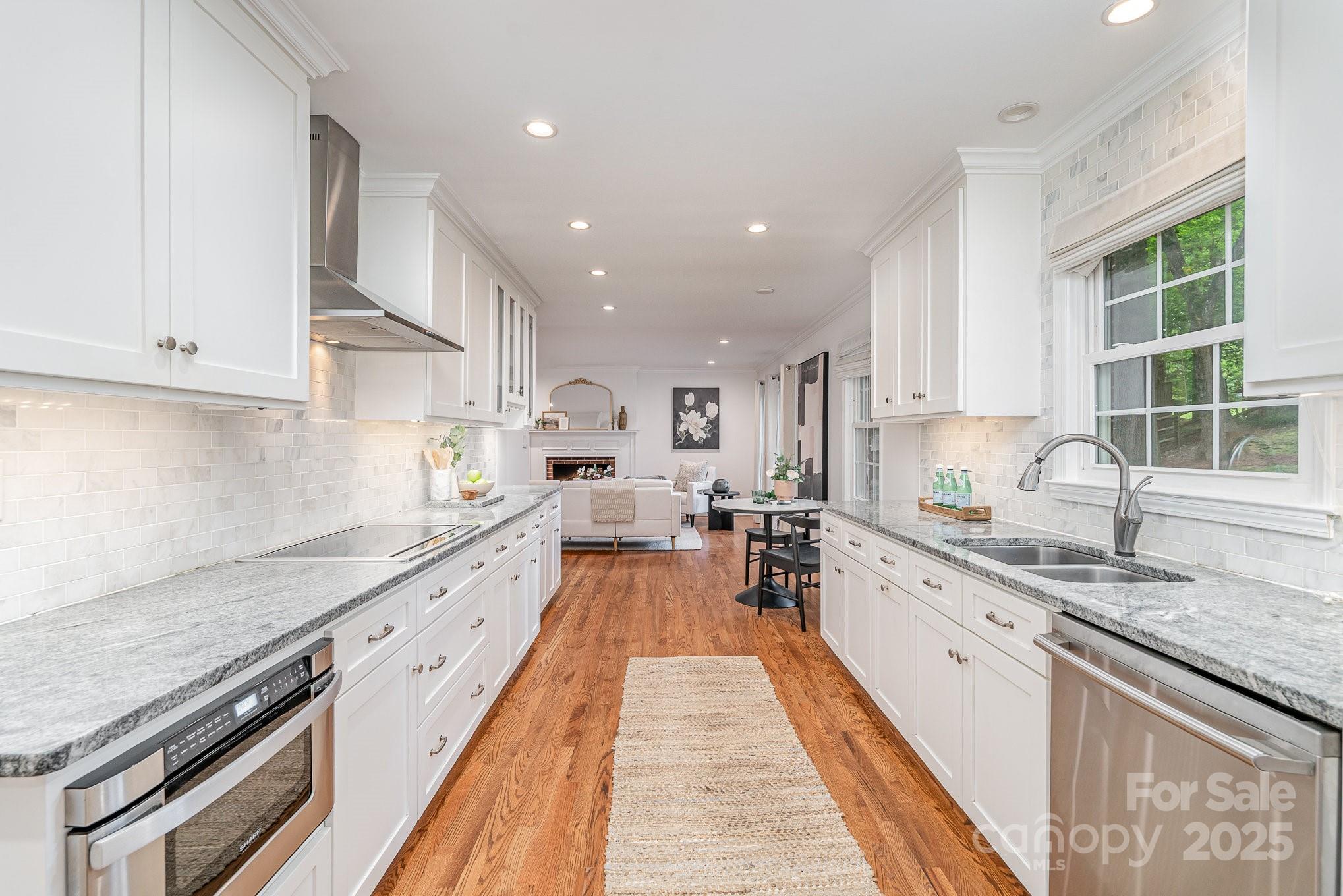 6749 Windyrush Road Charlotte, NC 28226 - Photo 11 of 30 a large kitchen with stainless steel appliances granite countertop a lot of counter space and a sink