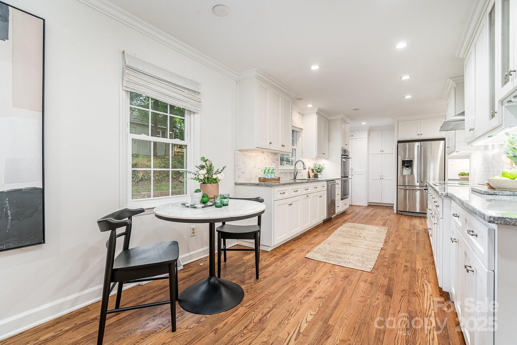6749 Windyrush Road Charlotte, NC 28226 - Photo 12 of 30 a living room with stainless steel appliances kitchen island granite countertop furniture and wooden floor