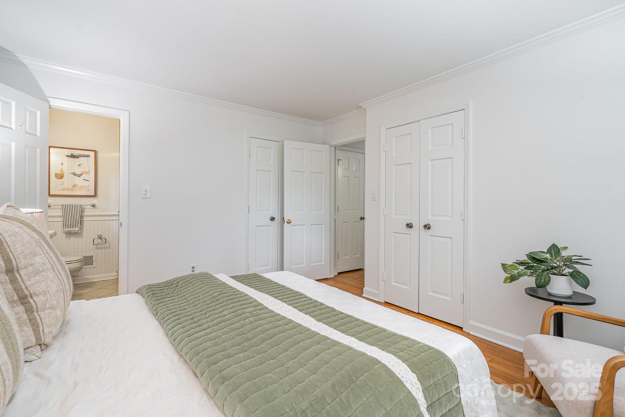 6749 Windyrush Road Charlotte, NC 28226 - Photo 20 of 30 a bedroom with a bed and a potted plant