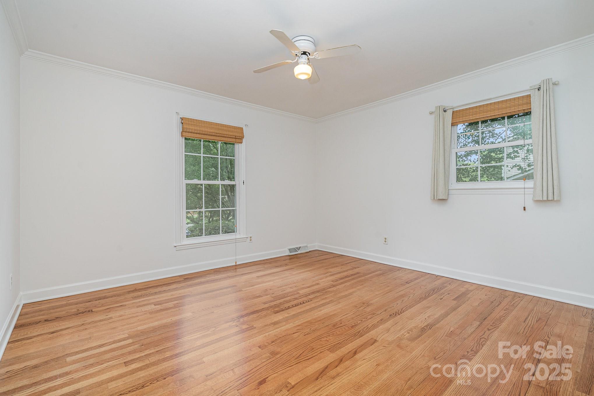 6749 Windyrush Road Charlotte, NC 28226 - Photo 22 of 30 a view of an empty room with wooden floor and a window