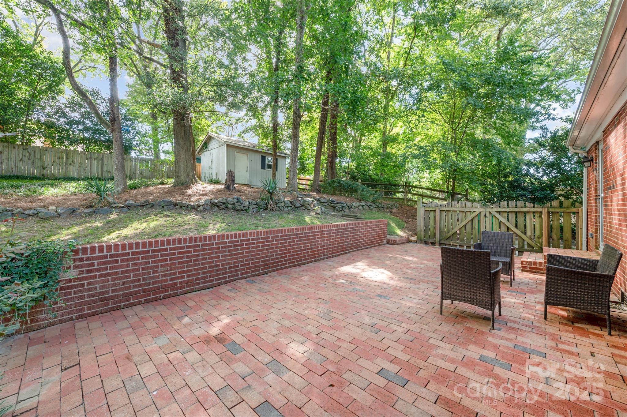 6749 Windyrush Road Charlotte, NC 28226 - Photo 25 of 30 a view of a bench and trees in the back yard