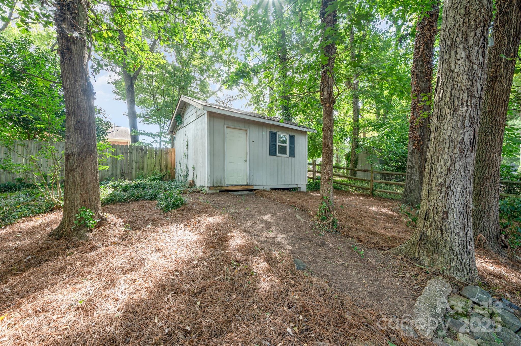 6749 Windyrush Road Charlotte, NC 28226 - Photo 30 of 30 a view of a house with large trees and a large tree