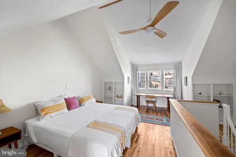 a bed room with a bed and a view of kitchen