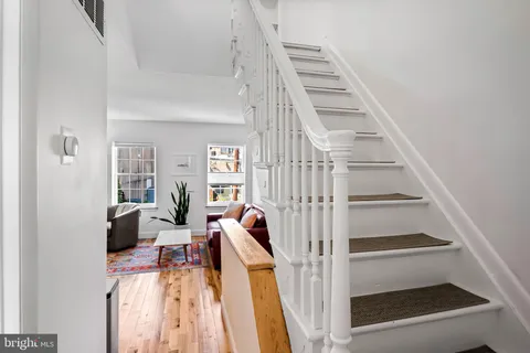 a view of entryway and hall with wooden floor