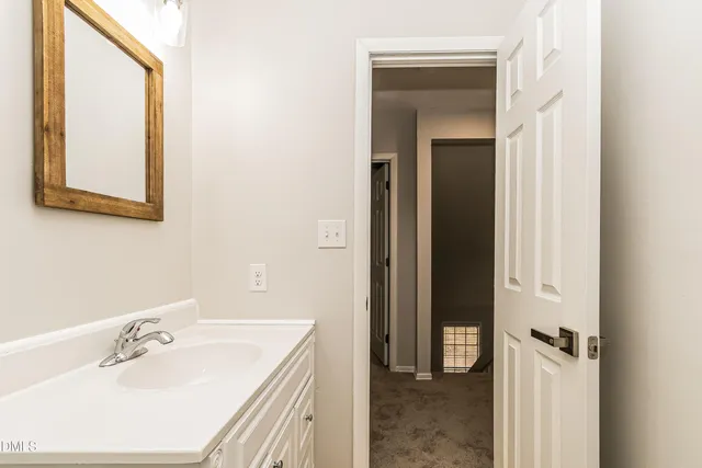 a bathroom with a sink and mirror