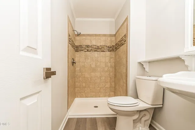 a bathroom with a toilet and a shower