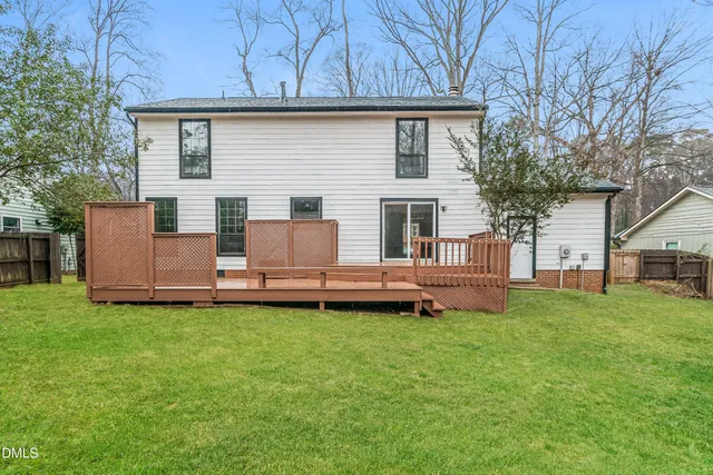 a backyard of a house with table and chairs