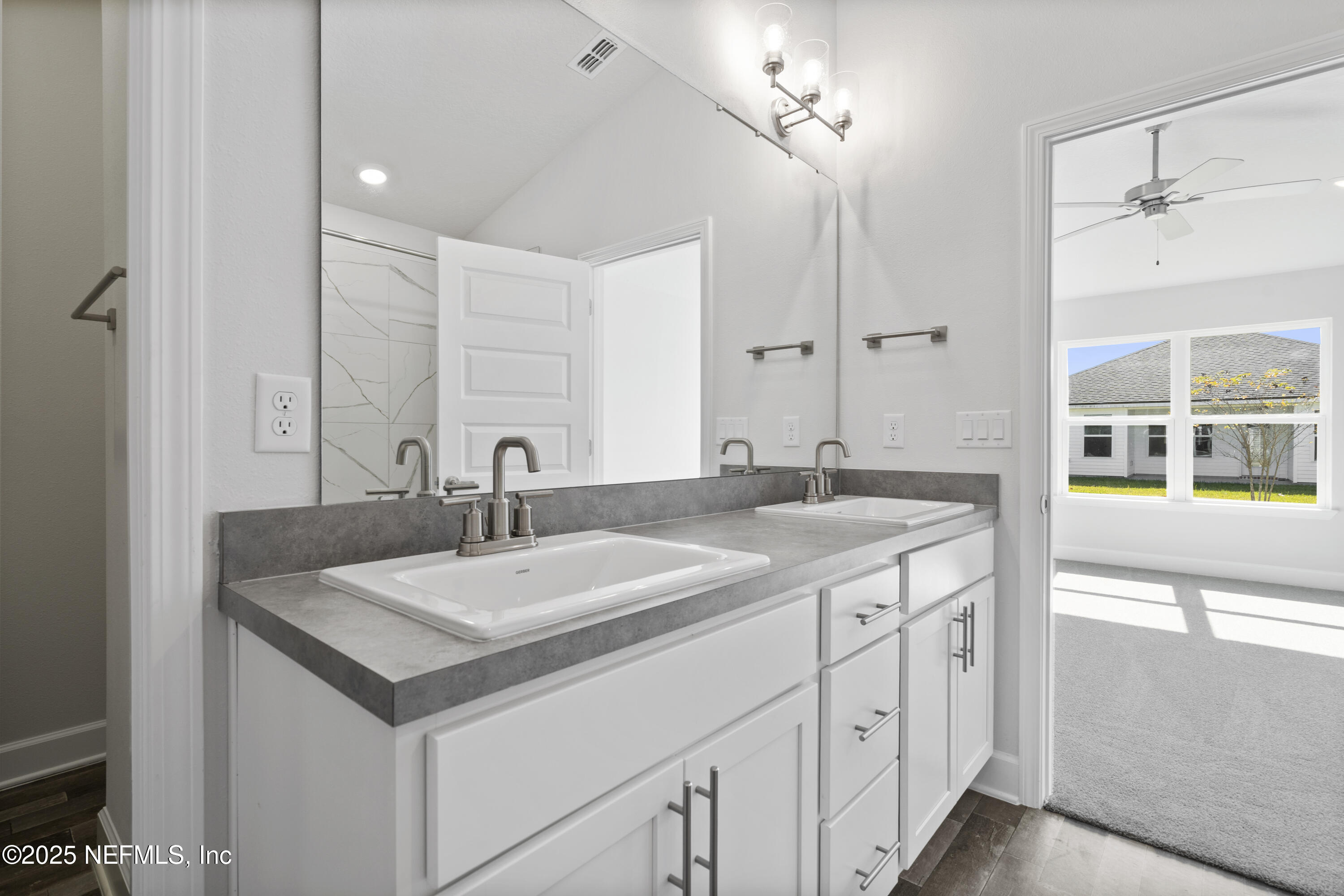 8346 Helmsley Boulevard Jacksonville, FL 32219 - Photo 11 of 24 a bathroom with a sink and a mirror