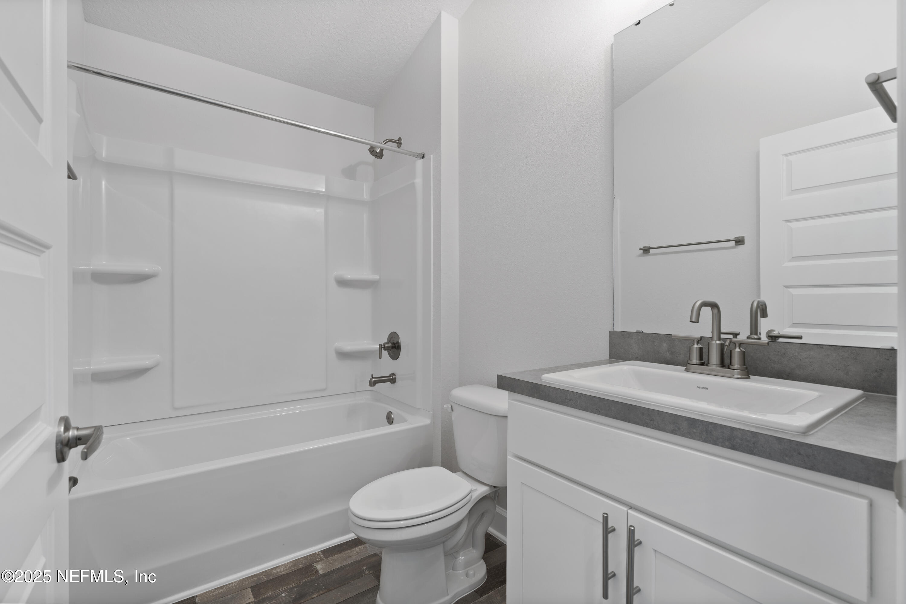 8346 Helmsley Boulevard Jacksonville, FL 32219 - Photo 13 of 24 a bathroom with a sink toilet vanity and shower