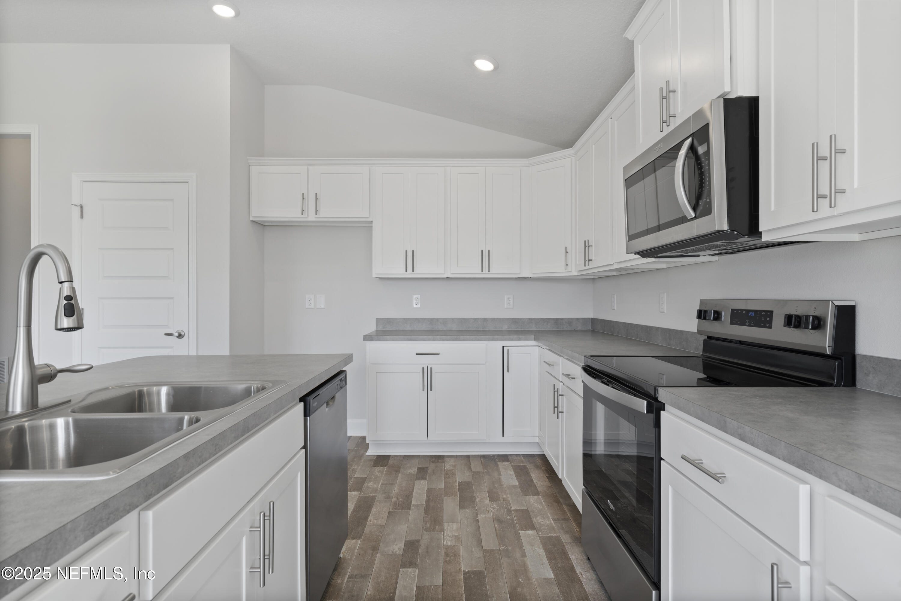 8346 Helmsley Boulevard Jacksonville, FL 32219 - Photo 4 of 24 a kitchen with stainless steel appliances granite countertop a sink and a stove