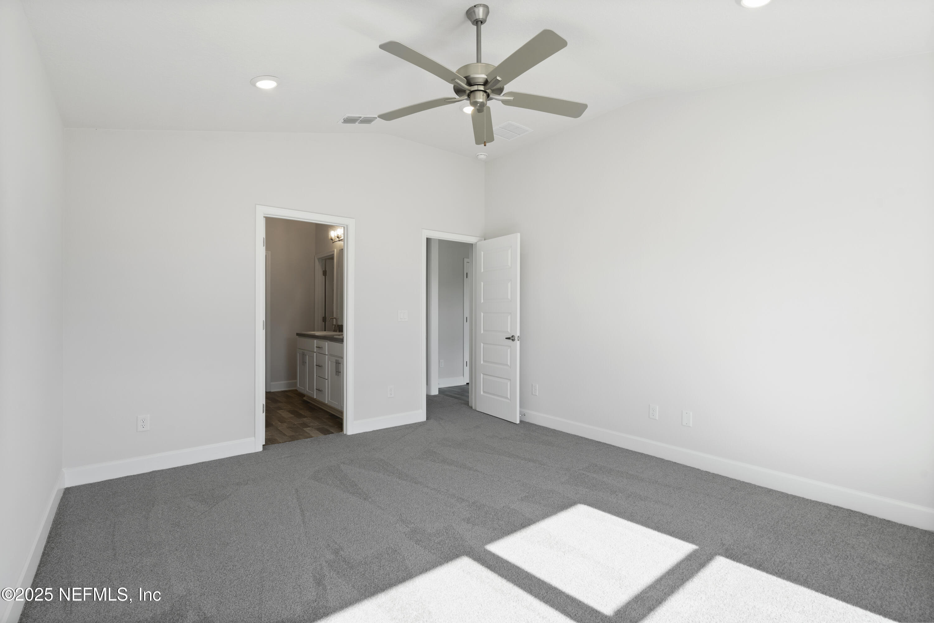 8346 Helmsley Boulevard Jacksonville, FL 32219 - Photo 8 of 24 an empty room with a ceiling fan and a window