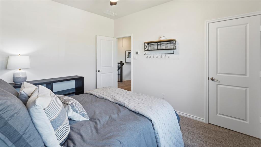 4197 Waldron Trail Forney, TX 75126 - Photo 23 of 25 Carpeted bedroom featuring neutral paint, white trim, and a ceiling fan