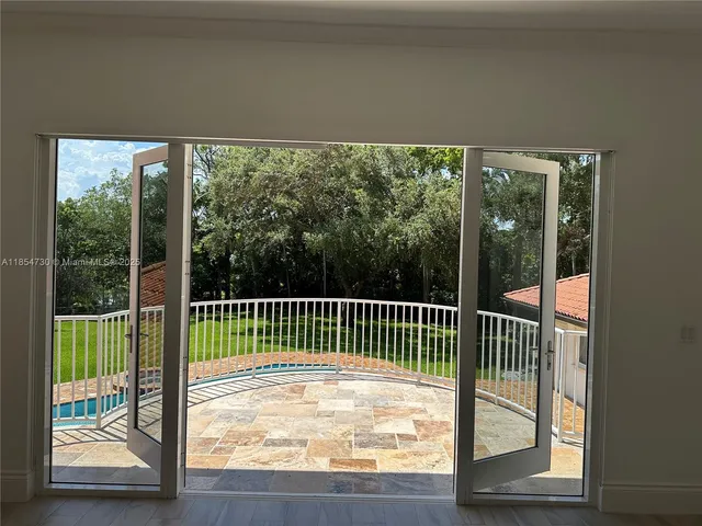 a view of an empty room and a window
