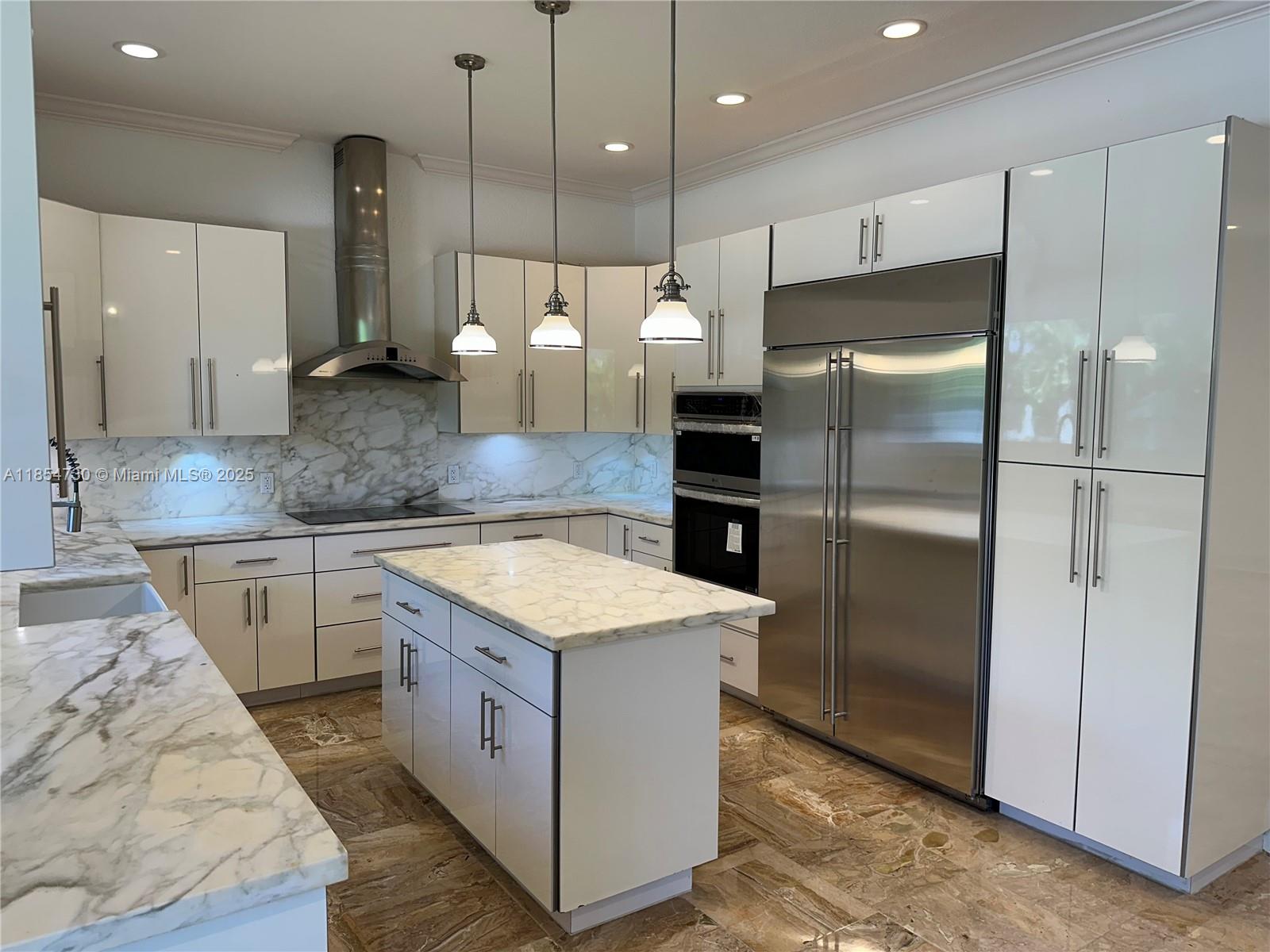 10600 Southwest 69th Avenue Pinecrest, FL 33156 - Photo 3 of 55 a kitchen with a refrigerator a sink and wooden floor