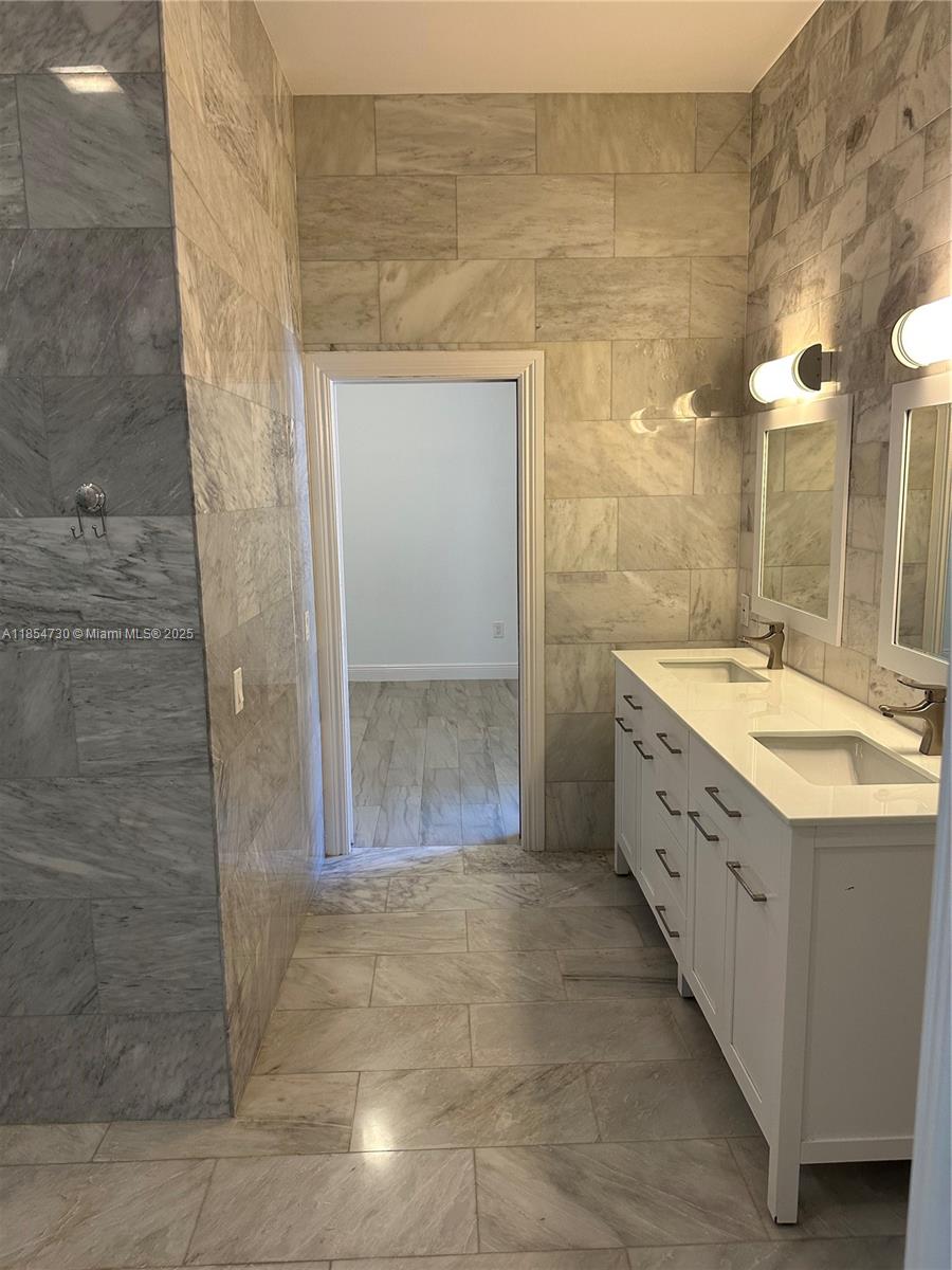 10600 Southwest 69th Avenue Pinecrest, FL 33156 - Photo 36 of 55 a bathroom with a double vanity sink mirror and shower