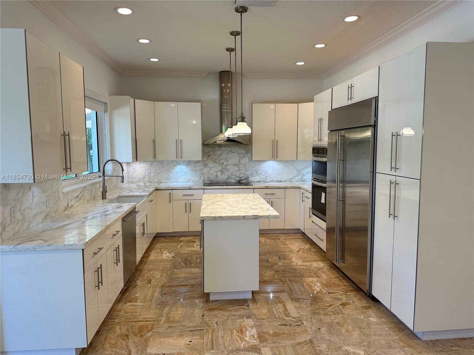 10600 Southwest 69th Avenue Pinecrest, FL 33156 - Photo 4 of 55 a large kitchen with stainless steel appliances kitchen island granite countertop a refrigerator a sink and a stove