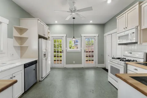 a kitchen with stainless steel appliances a stove sink and refrigerator