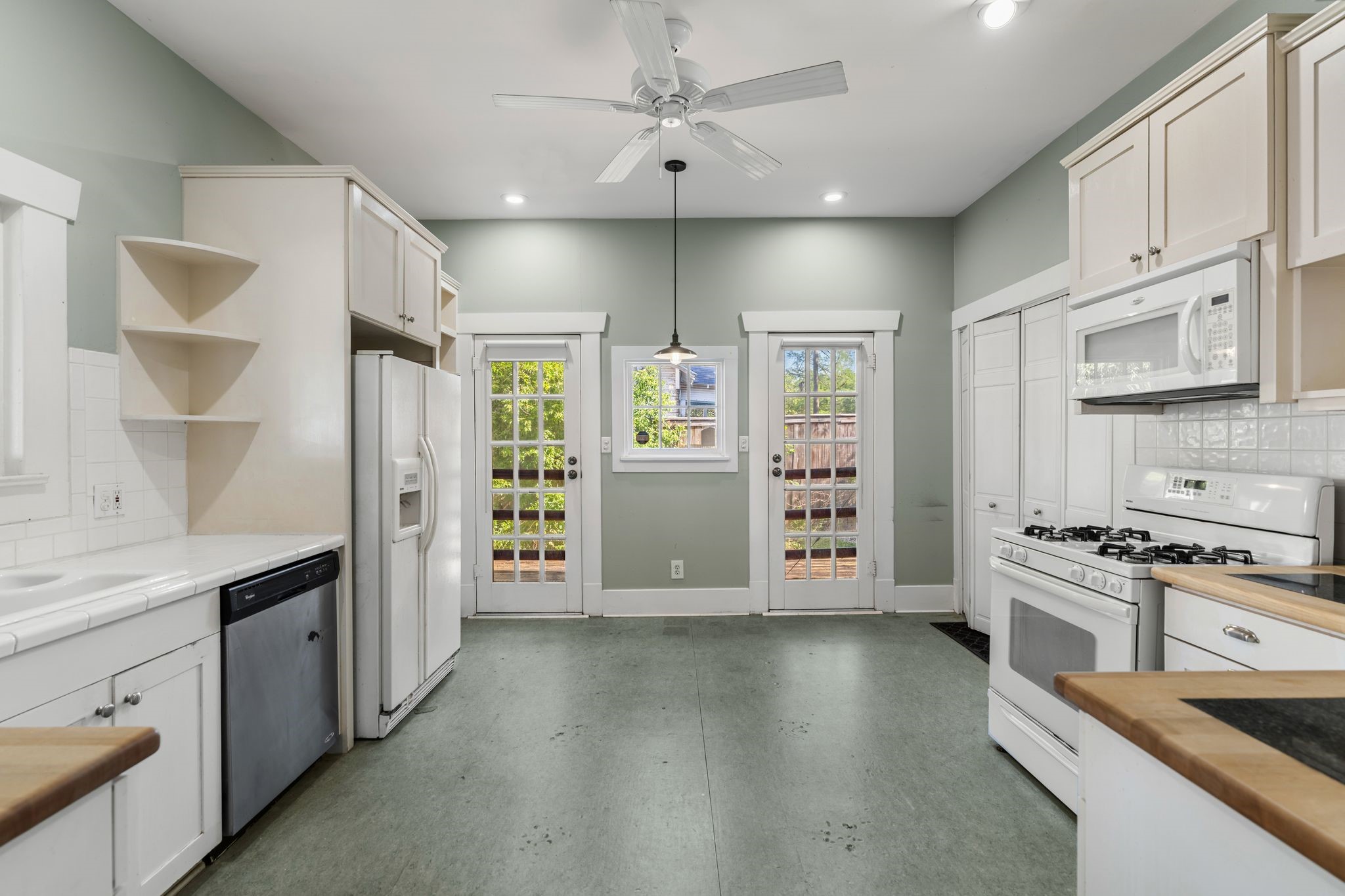 217 Teetshorn Street Houston, TX 77009 - Photo 11 of 21 a kitchen with stainless steel appliances a stove sink and refrigerator