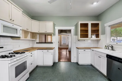 a kitchen with stainless steel appliances granite countertop a stove sink and cabinets